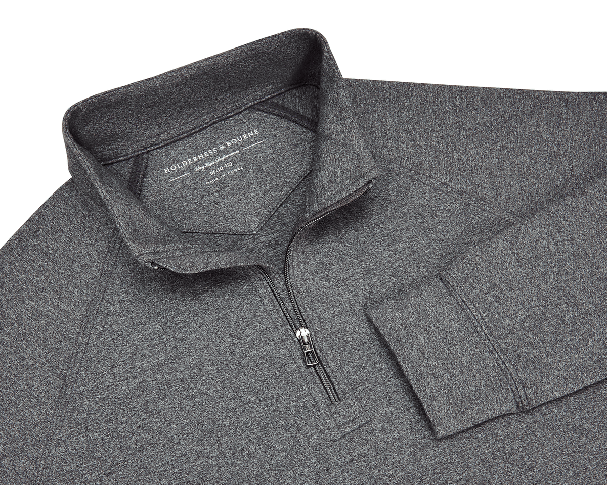 The Westland Boys Quarter-Zip: Charcoal, featuring a heathered design, stand-up collar, and quarter-length zipper, offering UPF 50+ protection and 4-way stretch for comfort.
