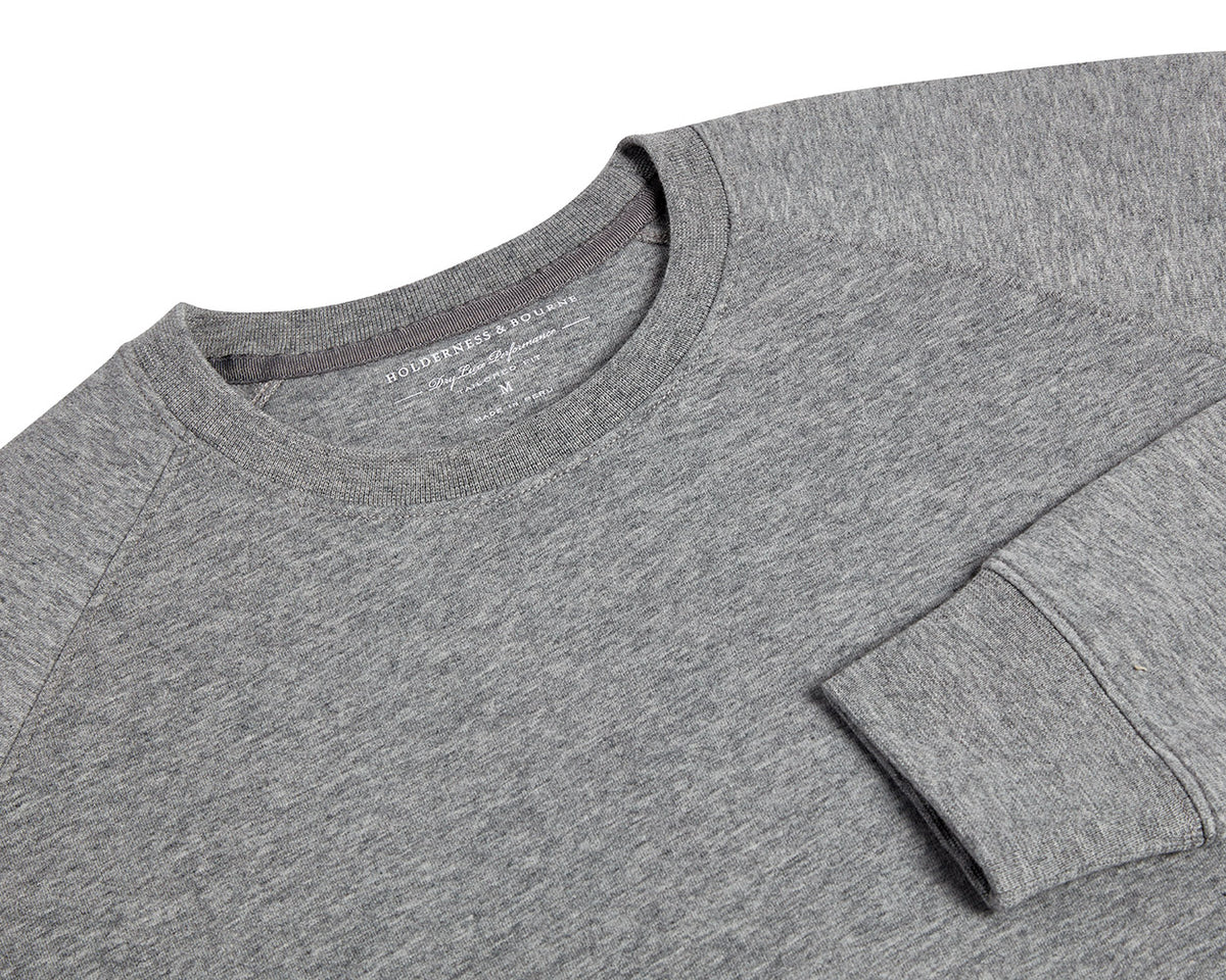 The Kennedy Crewneck: Heathered Gray, featuring a crew-neck design with visible collar, shoulder seams, and cuff, crafted from a soft cotton blend with terry interior.