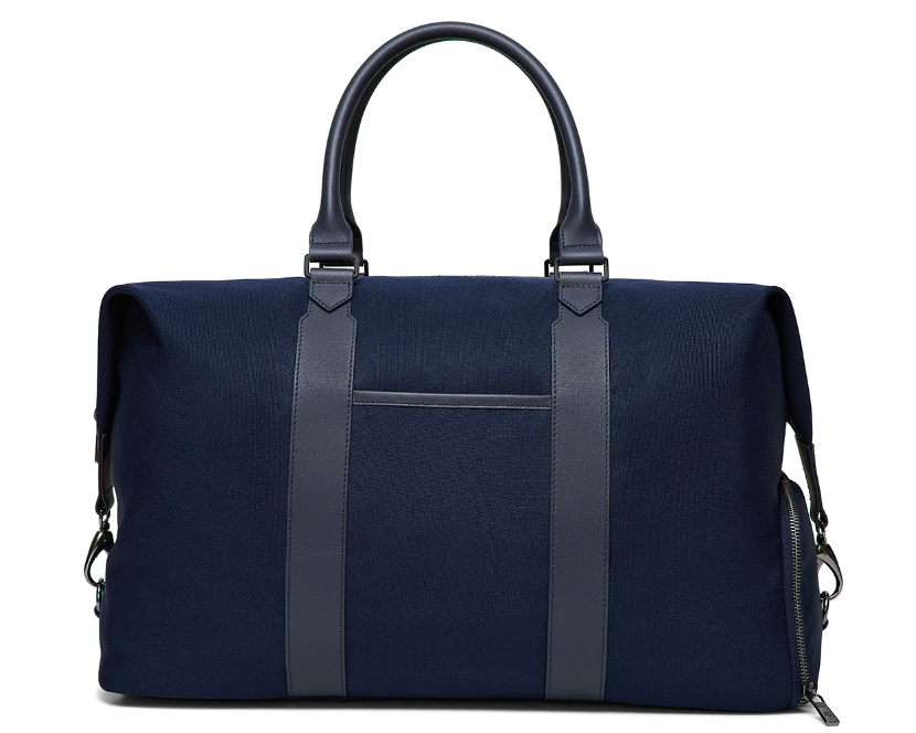 The Byers Duffel Bag: Navy Ballistic, featuring sturdy fabric, leather handles, vertical front straps, and a zippered side pocket, ideal for travel with easy-access top opening.