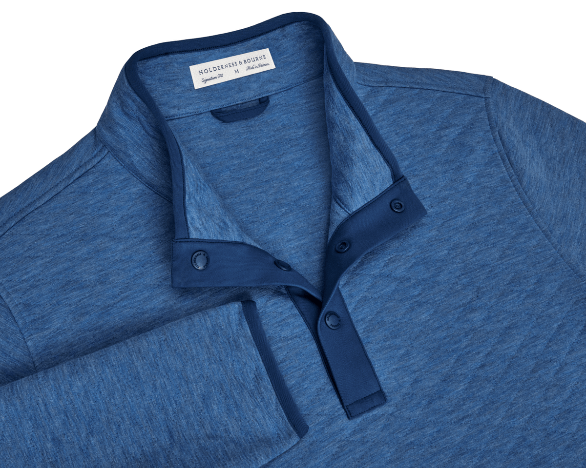 The Sullivan Quarter-Snap in Heathered Maidstone Blue, a soft pullover with a stand-up collar, three-snap placket, and diamond-quilted insulation for warmth.