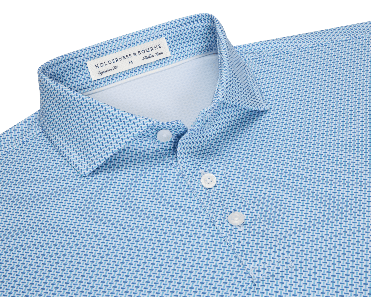 The Norman Shirt: Harbor & Maidstone Blue, a light-blue polo with subtle dark blue geometric pattern, classic collar, and three-button placket, featuring UPF 50+ protection.