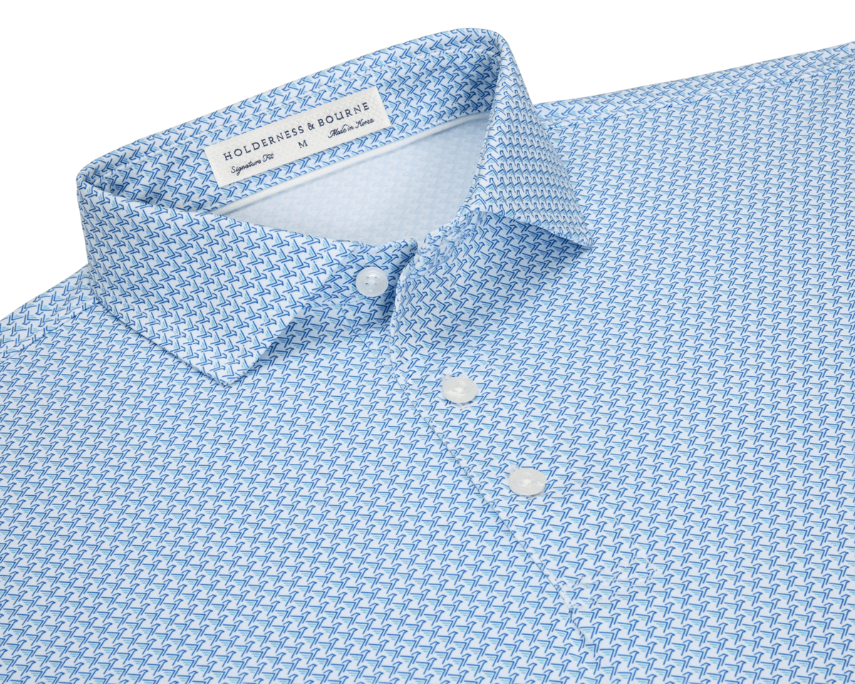 The Justice Shirt: Harbor & Maidstone Blue, featuring a light-blue polo with a navy eagle pattern, structured collar, and three white buttons.