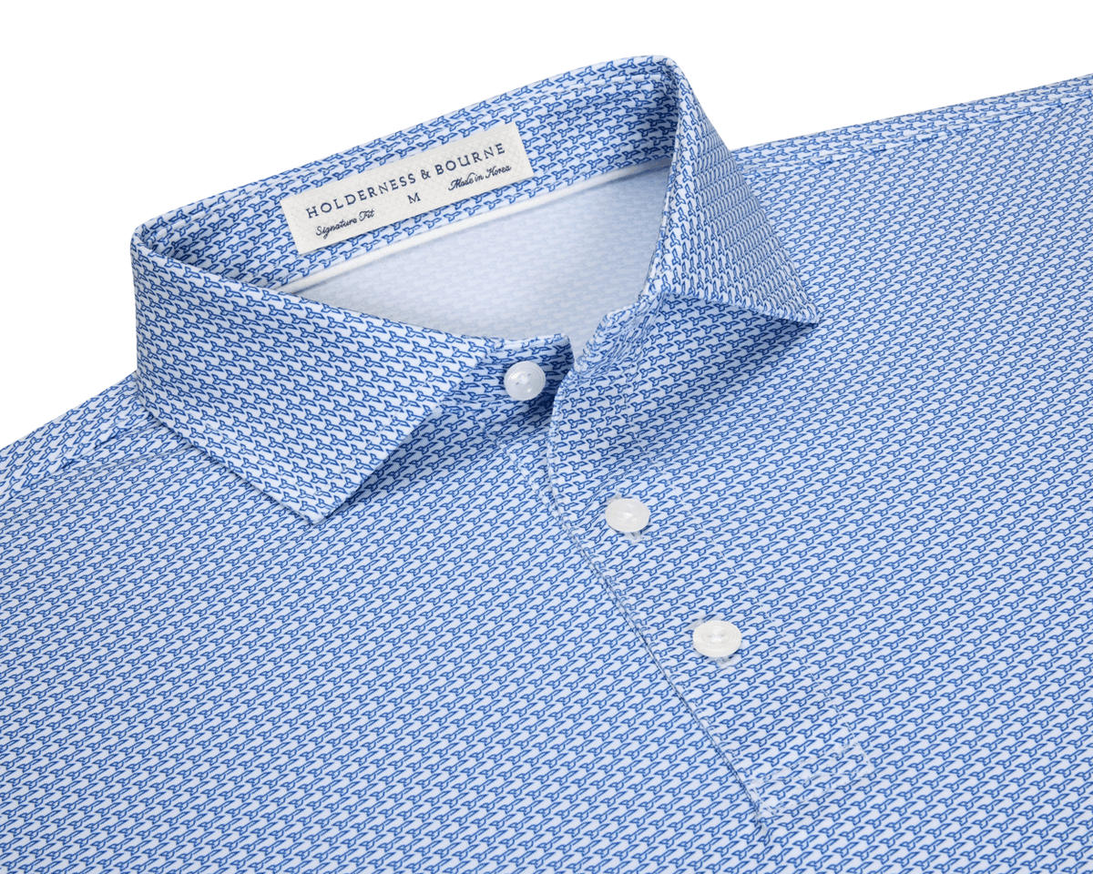 The Hanover Shirt: Maidstone Blue, a slim-fit men's button-down with spread collar, features a blue geometric pattern on white, offering comfort and sun protection.