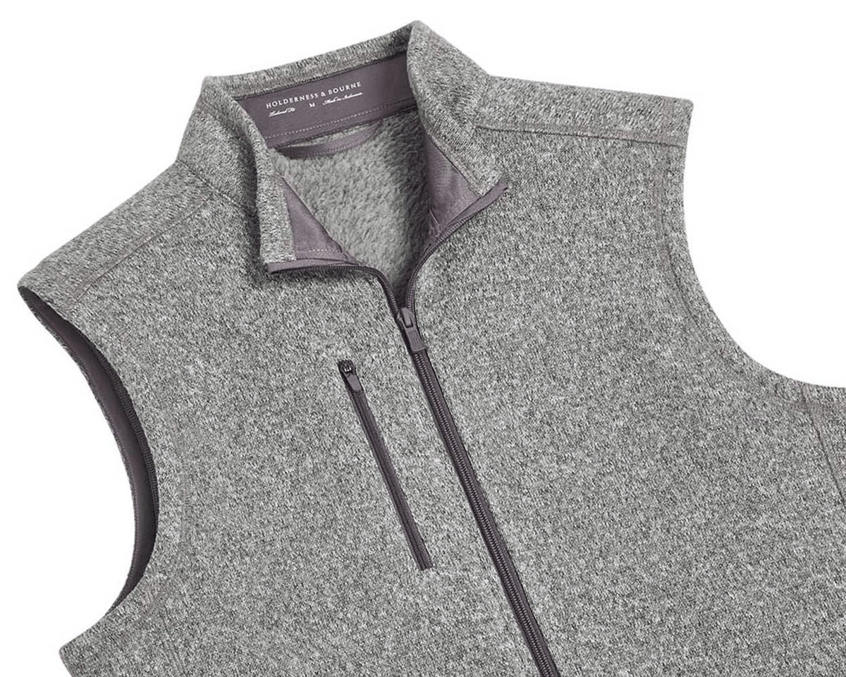 The Ashby Vest: Heathered Gray men's sleeveless zip-up with stand-up collar, zippered chest pocket, and tonal accents. Features a buttery soft interior and H&B embroidery.
