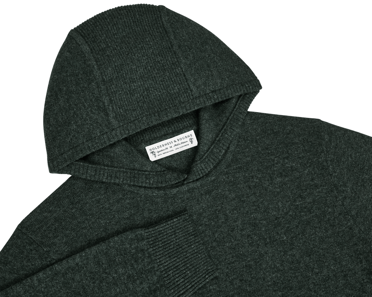 The Logan Hoodie Sweater: Heathered Ivy, in dark green, knit with Merino wool-cashmere blend, features ribbed detailing and a woven Holderness & Bourne label at the neckline.