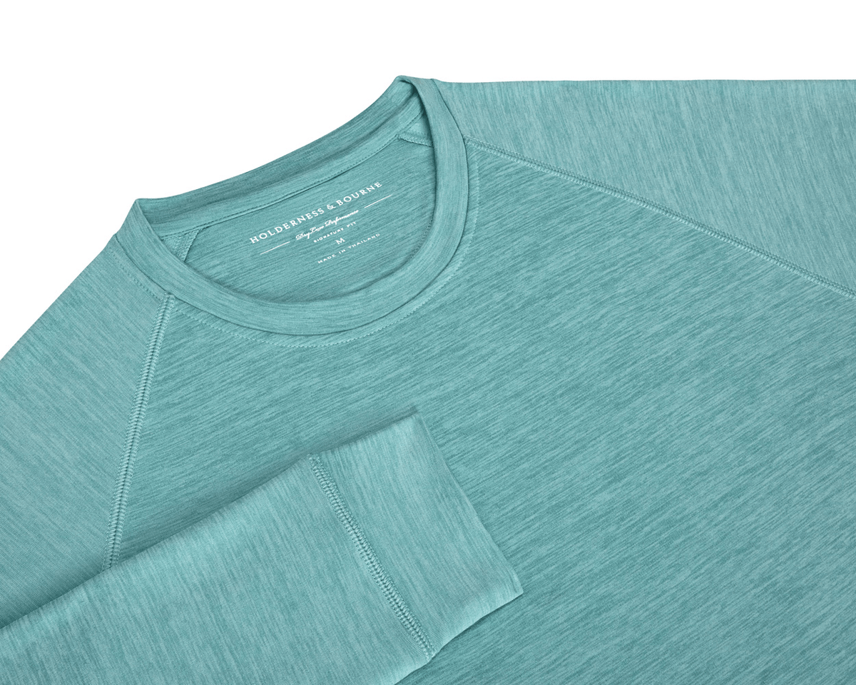 The Laidlay Crewneck: Heathered Harbor, a soft, stretchy raglan-style pullover with a heathered texture, showcasing the Holderness & Bourne neck label.