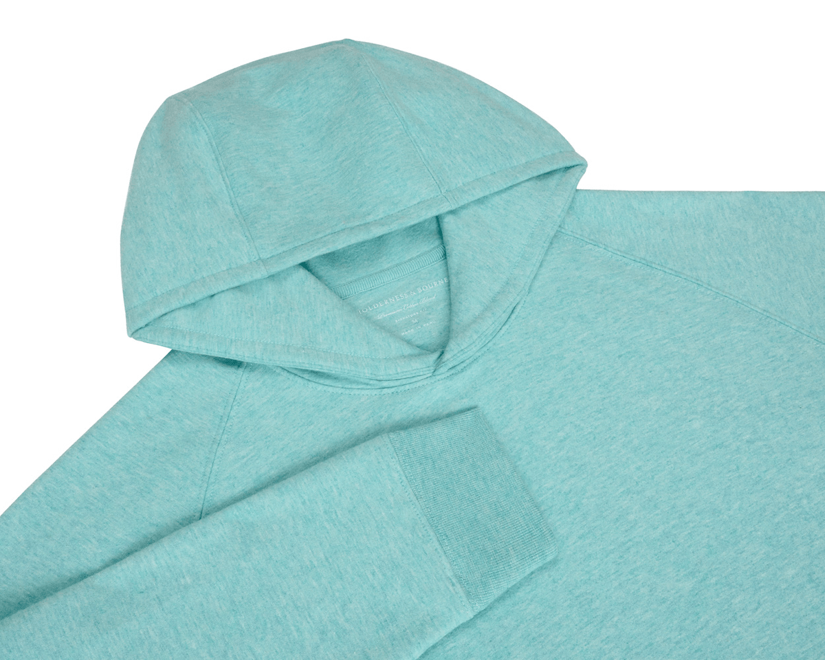 The Lawson Hoodie: Heathered Harbor, featuring an aqua pullover design with visible hood and sleeve cuff, offers ultra-soft comfort for versatile, casual wear.