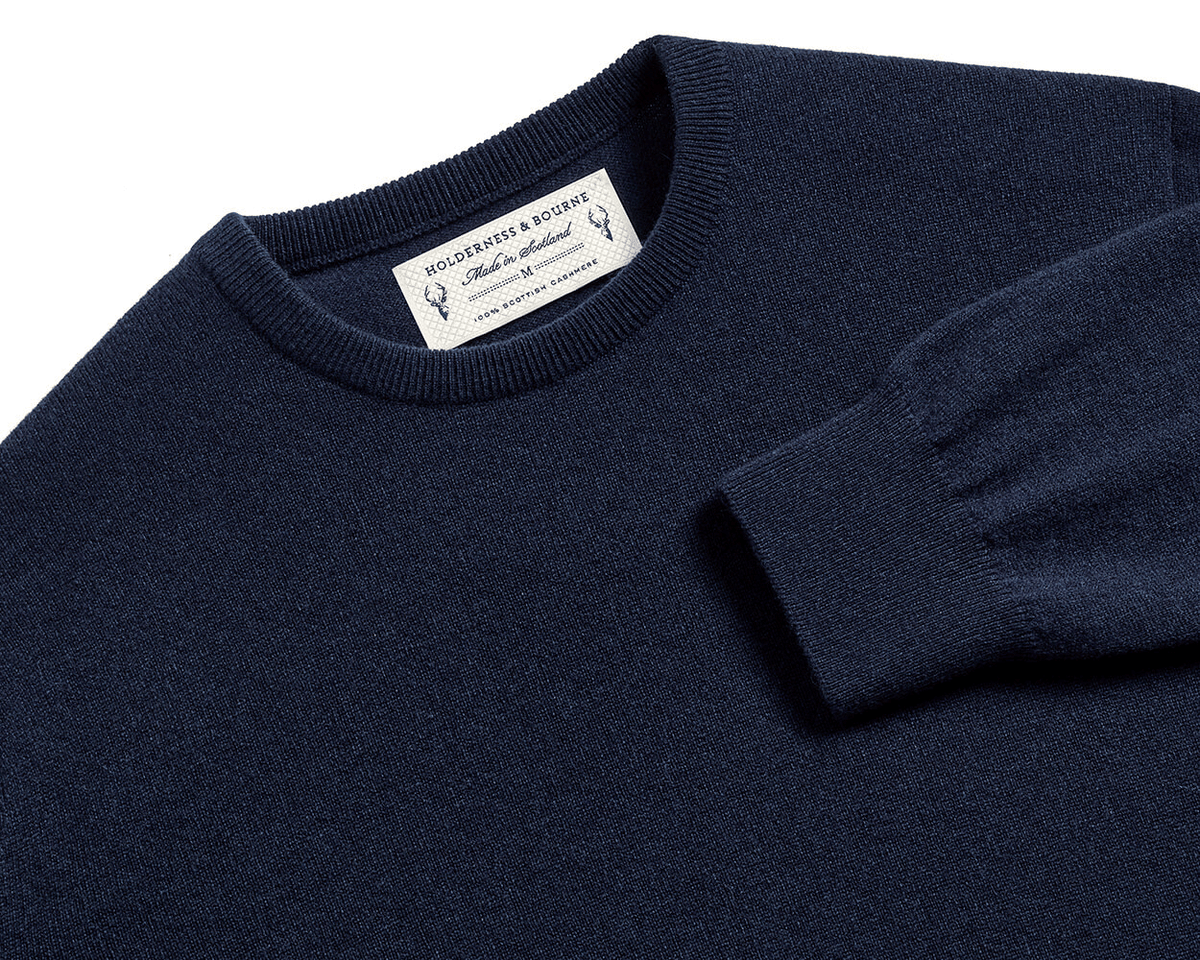 The Buckley Crewneck Sweater: Heathered Dark Navy, crafted from 100% Scottish cashmere, features a classic crewneck and durable doubled cuff design.