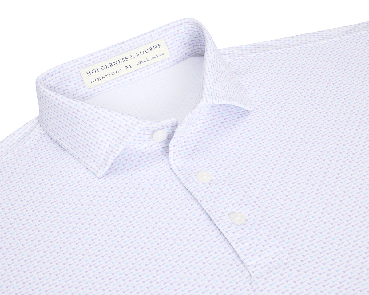 The Cadogan Shirt: Tudor & Vista Blue, a men's white polo with lavender micro-pattern, three buttons, and breathable AIRATION® fabric for cooling comfort.