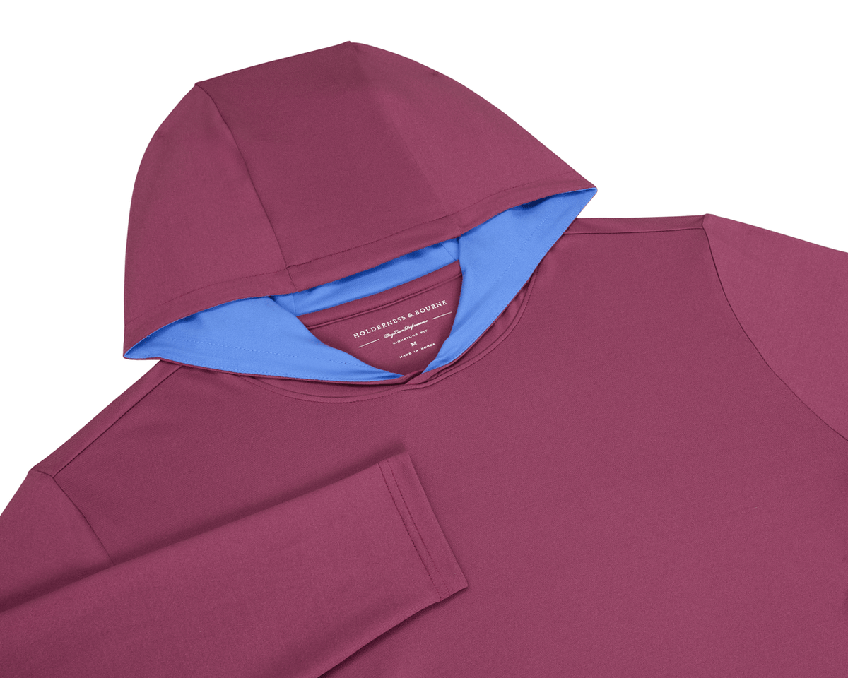 The Jackson Hoodie: Cabernet, flat-lay view, showcasing its streamlined design with a soft performance fabric, burgundy exterior, and contrasting light blue hood lining.