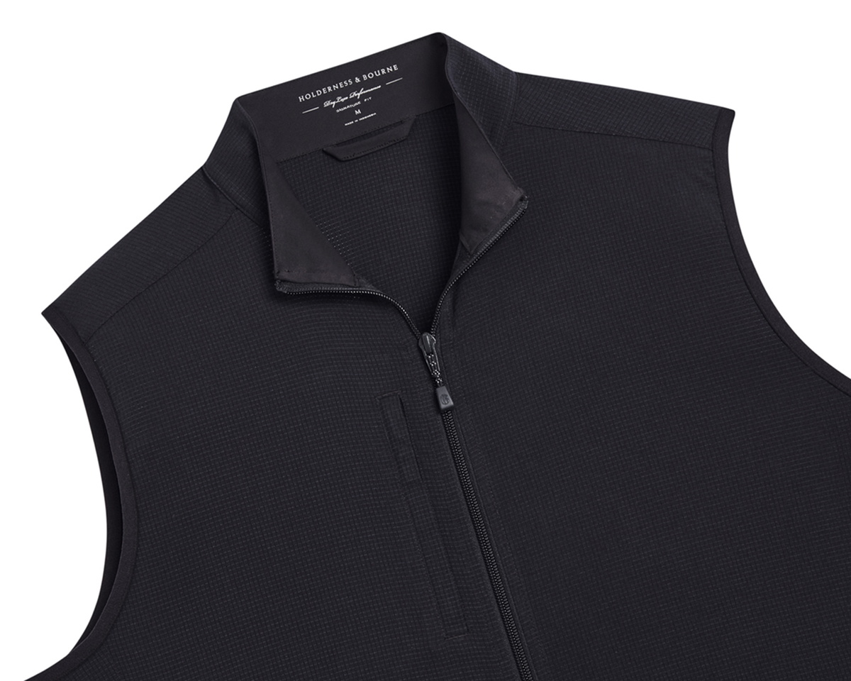 The Ventura Vest: Black, men’s sleeveless, zip-front vest with a stand-up collar, grid-textured knit, and hidden zippered chest pocket, ideal for warm weather layering.