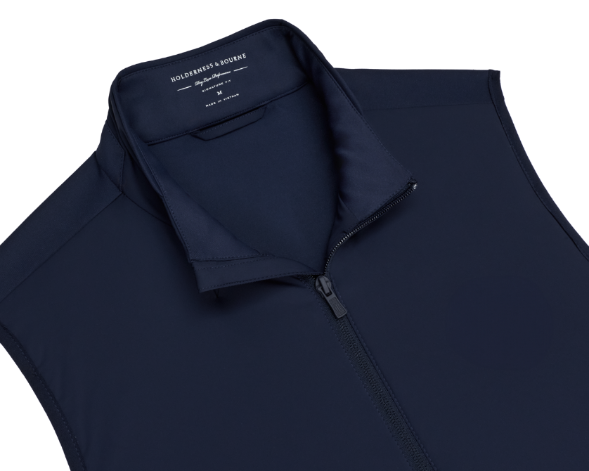 The Swenson Vest: Navy, a sleeveless, zip-front vest by Holderness & Bourne, features lightweight Thermore® insulation and stretch fabric for optimal golf performance.