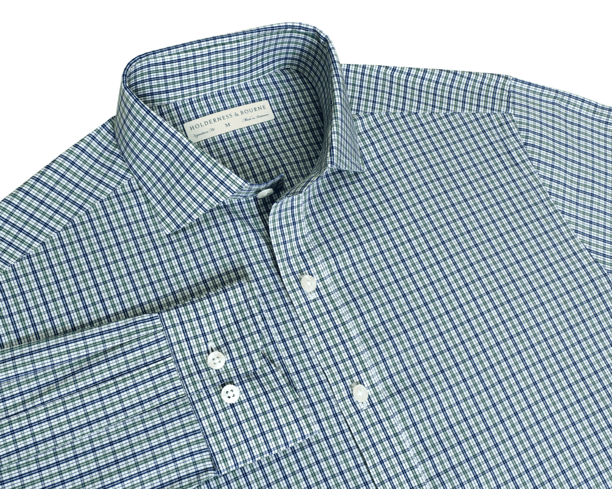 The Mendenhall Shirt: California Spruce & Navy flat-lay showing its two-color plaid, cutaway collar with brand label, button cuffs, and front placket.