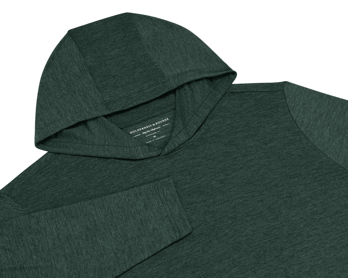 The Stowe Hoodie: Heathered Cypress flat-lay showing its hood, long sleeves, and heathered dark green lightweight performance fabric.