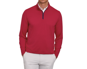Person wearing The Bell Quarter-Zip: Heathered Liberty Red over a white shirt, paired with light-beige trousers, hands in pockets, showcasing a sporty, sophisticated style.