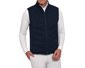 The Benton Vest: Navy, a quilt-style zip-up with Thermore® insulation, shown over a white shirt and light trousers, highlighting its comfort and mobility features.