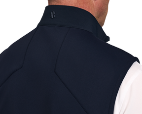 The Benton Vest: Navy, showcasing a close-up of the back with seam lines and a small logo on the standing collar, emphasizes comfort and mobility.