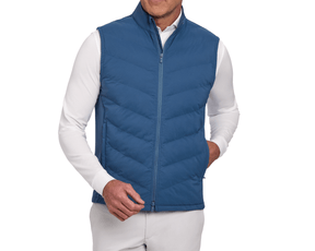 The Benton Vest: Andover, a quilted vest with a high collar and side pockets, features Thermore® insulation and a two-way zipper over a white shirt.