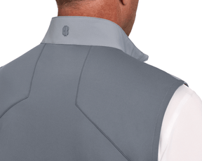 The Benton Vest: Gray, showcasing a soft-shell design with seam detailing and an embroidered logo on the collar, worn over a white shirt.