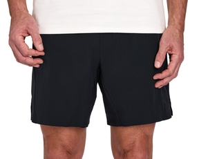 Person wearing The Saunders Short: Black, featuring a quick-drying tech blend and four-way stretch, with hands resting at sides.