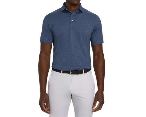 Model wearing The Maxwell Shirt: Navy & Heathered Pacific Blue, front view with a dark brown belt and light gray bottoms, arms relaxed at his sides.