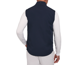 Back view of a model wearing The Boyd Vest: Navy, a sleeveless windbreaker with a two-way zipper over a long-sleeve shirt, highlighting its lightweight, flexible design.