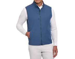 The Boyd Vest: Andover modeled, showcasing its lightweight, sleeveless design with zip-front, chest pocket, and hand pockets over a long-sleeve shirt and trousers.