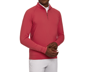 Person wearing The Westland Quarter-Zip: Liberty Red over a white collared shirt, paired with light-colored pants, showcasing its soft, moisture-wicking fabric.