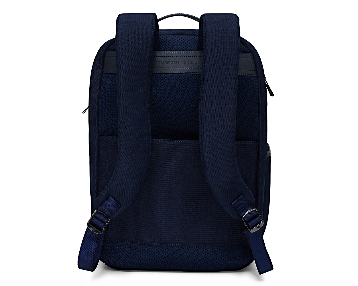 The Broughton Backpack: Navy Ballistic - Slate Blue Embroidery; back view with padded straps, mesh panel, side pockets, and debossed brand name near the top.