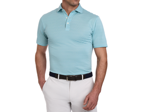 Man wearing The Maxwell Shirt: Harbor & White, a light blue-and-white striped polo, with off-white trousers and a dark woven belt, showcasing modern comfort and style.