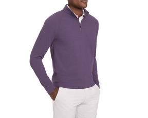 Man wearing The Westland Quarter-Zip: Heathered Amherst, showcasing a purple, lightweight pullover over a white shirt, hands in pockets of light pants.