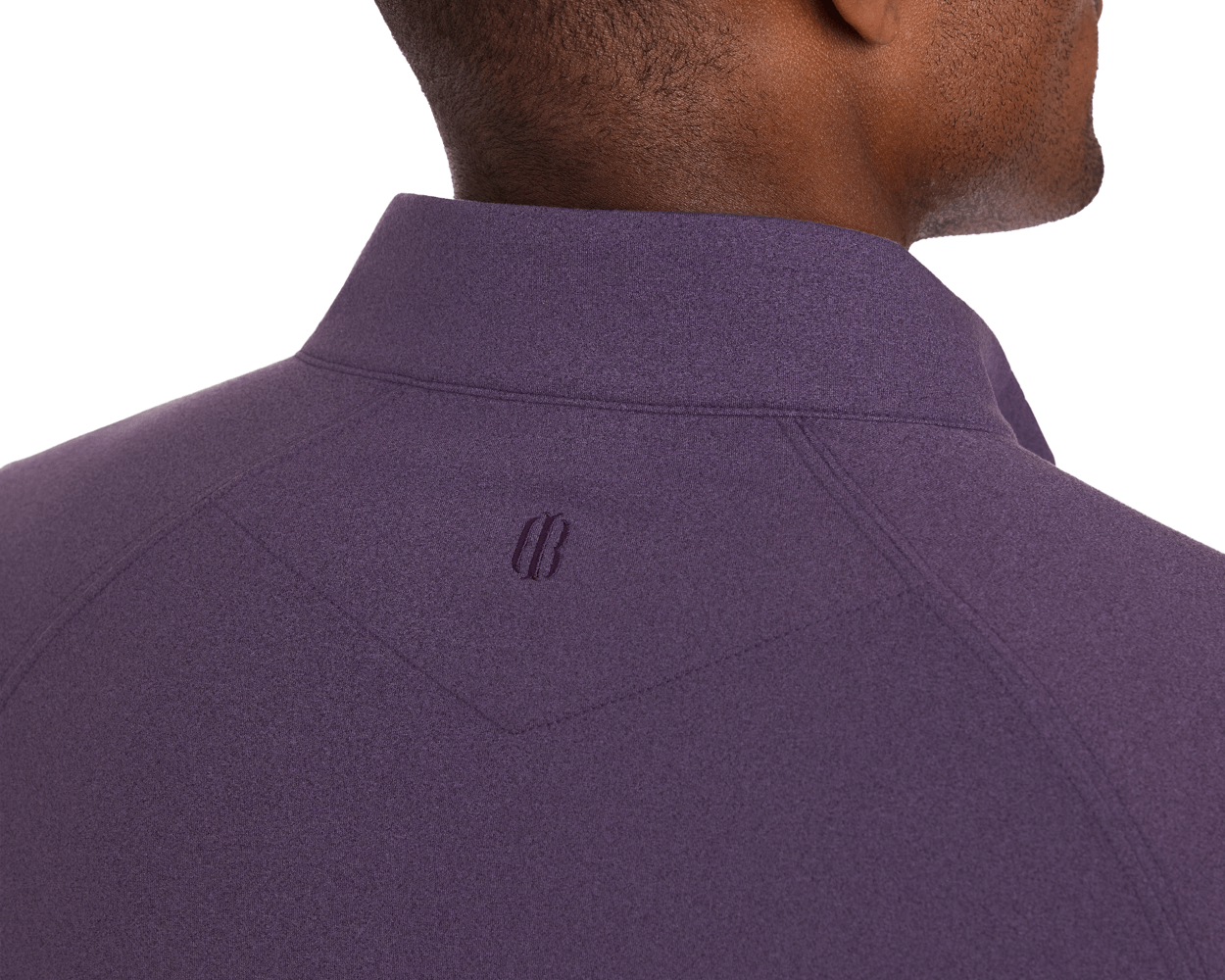 The Westland Quarter-Zip: Heathered Amherst, featuring a deep purple tone, smooth heathered texture, and tonal embroidered logo at the collar's base.
