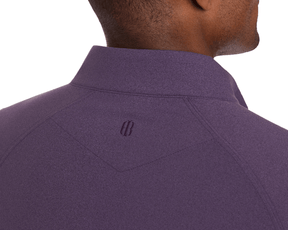 The Westland Quarter-Zip: Heathered Amherst, featuring a deep purple tone, smooth heathered texture, and tonal embroidered logo at the collar's base.