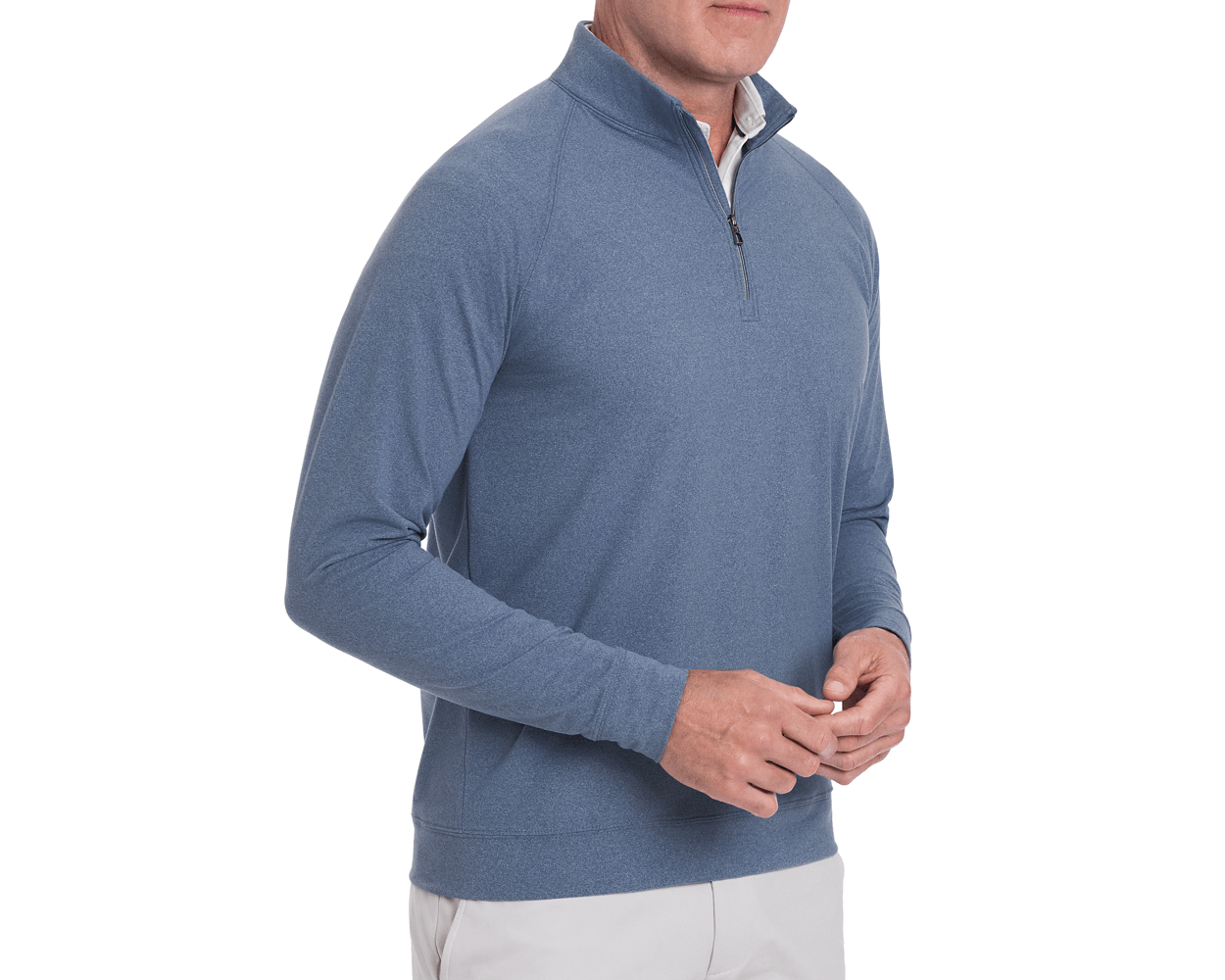 Man wearing The Westland Quarter-Zip: Heathered Andover, a light-blue pullover with a quarter-zip, over a white shirt, highlighting its technical, versatile design.