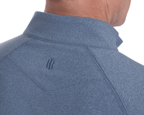 The Westland Quarter-Zip: Heathered Andover, showcasing a heather-blue mock-neck pullover with a tonal logo below the collar, designed for moisture-wicking and softness.