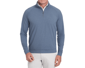 The Westland Quarter-Zip: Heathered Andover shown on a man, featuring a heather-blue peached fabric with moisture-wicking technology, over a white collared shirt.