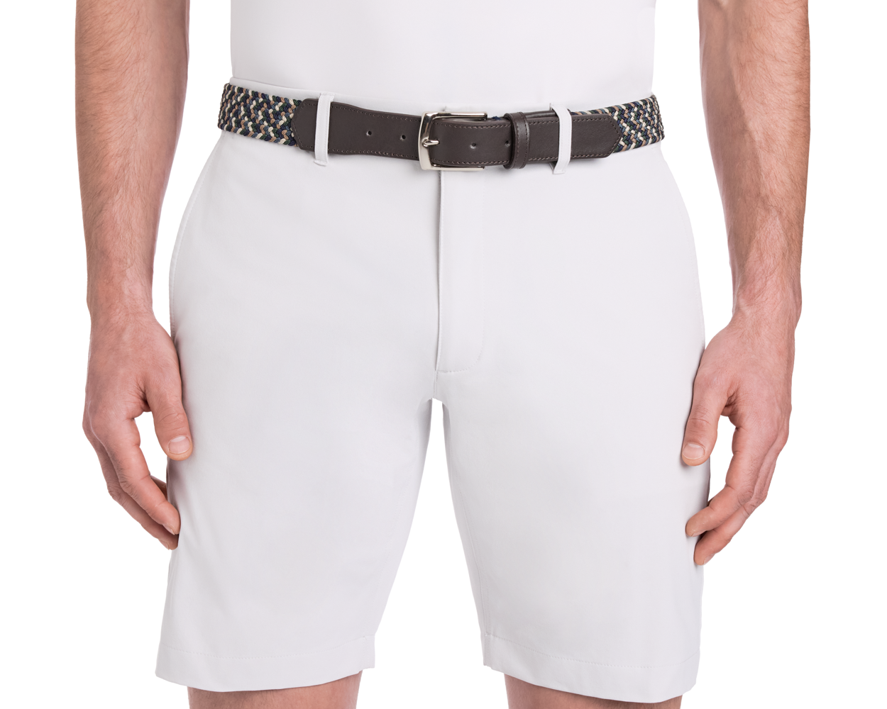 The Fischer Belt: Ivy Multicolor features a woven design with a dark leather buckle, shown on a model wearing white shorts, hands resting at sides.