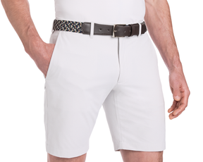 The Fischer Belt: Ivy Multicolor, woven with Italian stretch materials and genuine leather, complements light-colored knee-length shorts with side pockets.