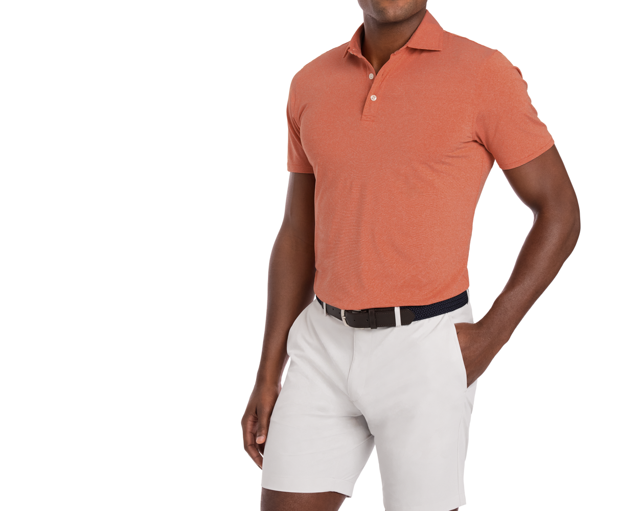 Man wearing Holderness & Bourne Men’s Orange Polo Shirt and white shorts.
