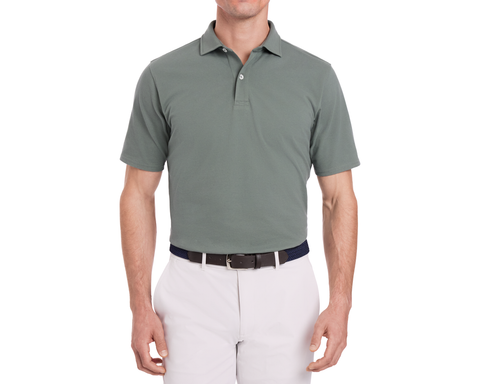The Neville Shirt: Ivy, a short-sleeve collared polo, tucked into light-gray trousers with a two-tone belt, showcasing a relaxed, signature fit.