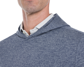 Close-up of a person wearing Holderness & Bourne Men’s Dark Blue Hoodie over a white shirt on a white background