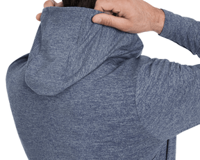 Person pulling on Holderness & Bourne Men’s Dark Blue Hoodie on a white background