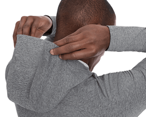 The Dunbar Hoodie: Heathered Charcoal on a male model, showcasing its hood being adjusted, emphasizing its lightweight and breathable design with a visible white T-shirt underneath.