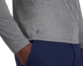Close-up of The Dunbar Hoodie: Heathered Charcoal, showcasing light-grey heathered fabric with textured side panel and BB logo near hem, paired with navy workout pants.
