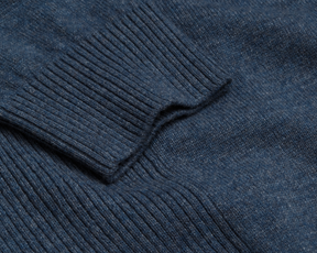 Close-up of The Logan Hoodie Sweater: Heathered Andover, showcasing rib-knit texture and folded cuff, highlighting its luxurious Merino wool-cashmere blend for warmth and breathability.