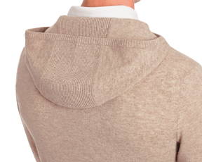 The Logan Hoodie Sweater: Heathered Dune, showcasing a rear view of its knit texture, with a shirt collar visible above the hood, emphasizing its elegant simplicity.