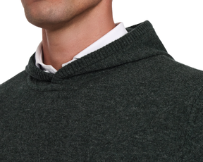 The Logan Hoodie Sweater: Heathered Ivy, showcasing its hooded neckline over a white dress shirt, highlighting its luxurious Merino wool and cashmere blend.