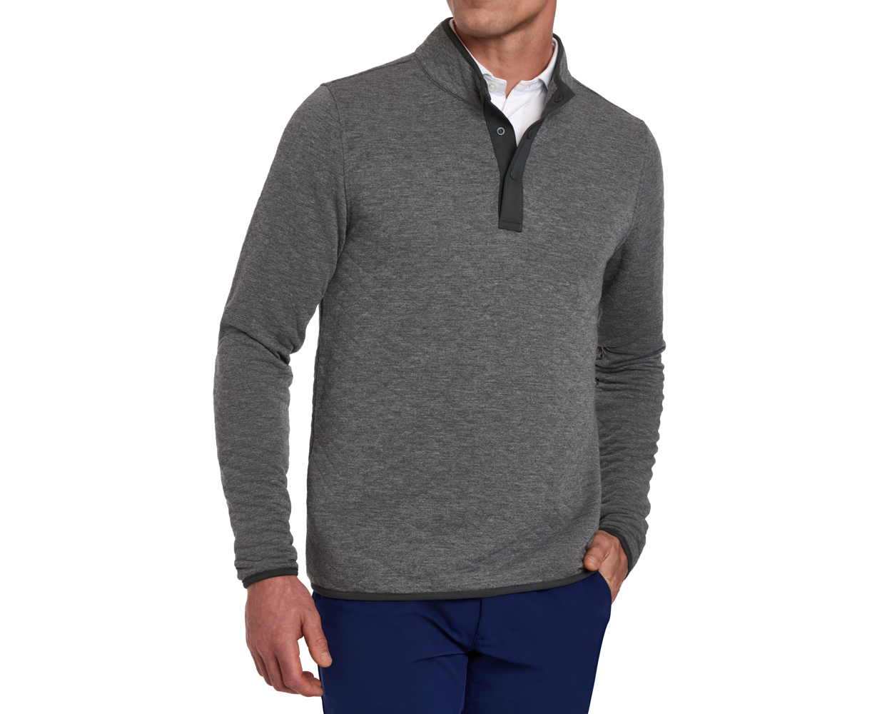 Man wearing The Sullivan Quarter-Snap: Heathered Charcoal, a long-sleeve pullover with snap-placket, layered over a white shirt, paired with navy trousers.
