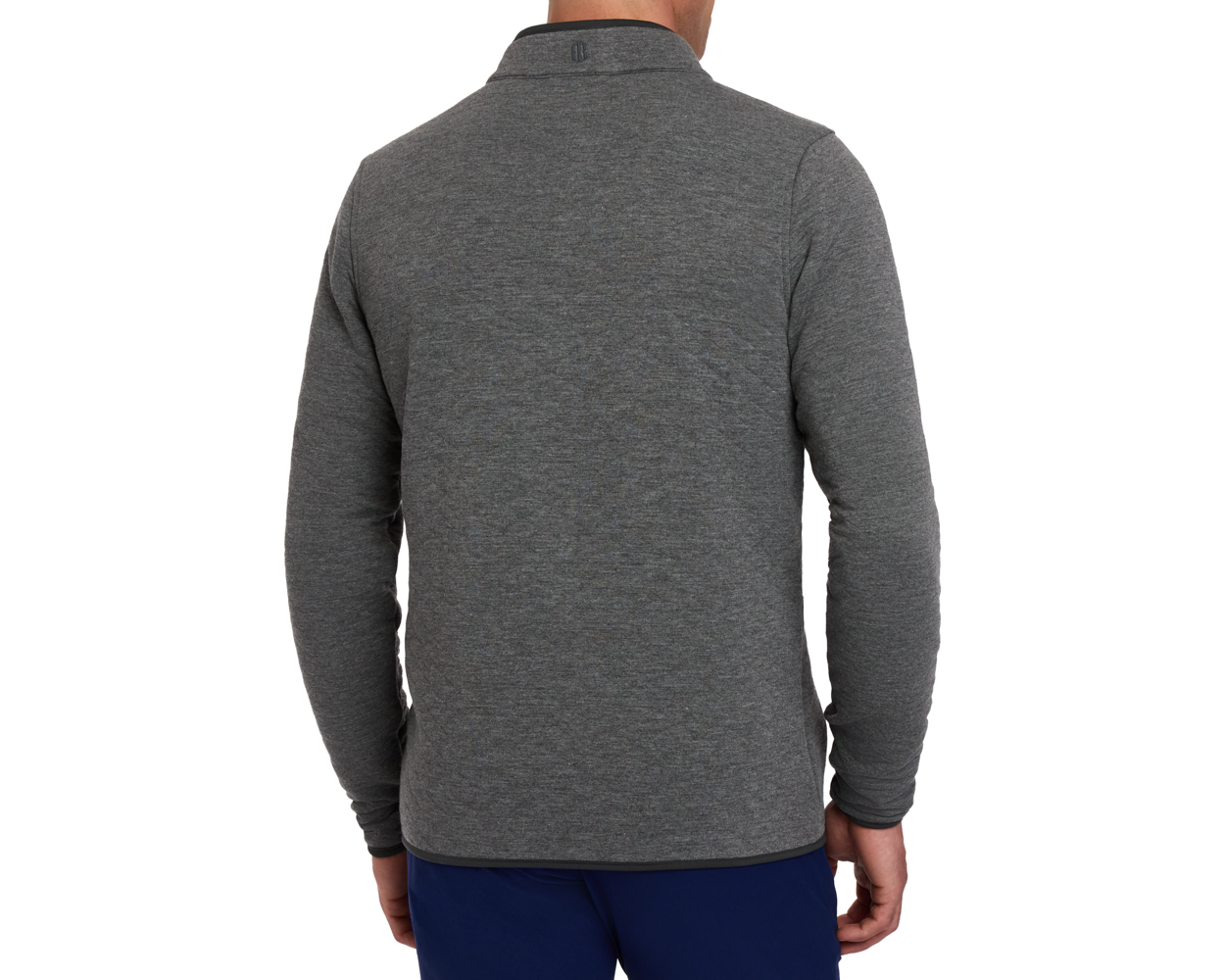 The Sullivan Quarter-Snap: Heathered Charcoal pullover with a stand-up collar and curved hem, worn with dark blue pants, showcasing its casual, versatile design.