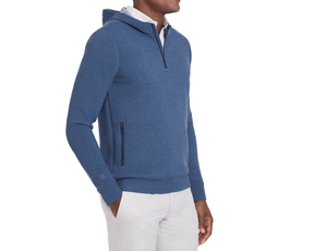 The Tilley Quarter-Zip Hoodie: Heathered Andover, features a sleek silhouette with a zipper neck and hip pockets, layered over a collared shirt.